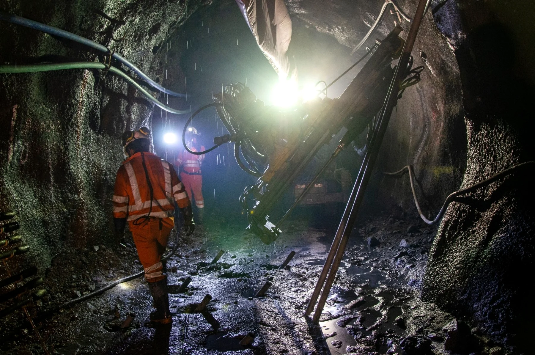 Workers and drilling machinery underground